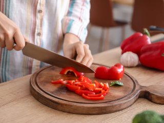 Consumer cutting bell pepper. Photo by Pixel-shot/Shutterstock.com