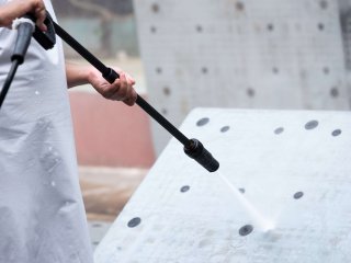 Cleaning with a pressure washer. Photo by Sorn340 Studio Images/Shutterstock.com